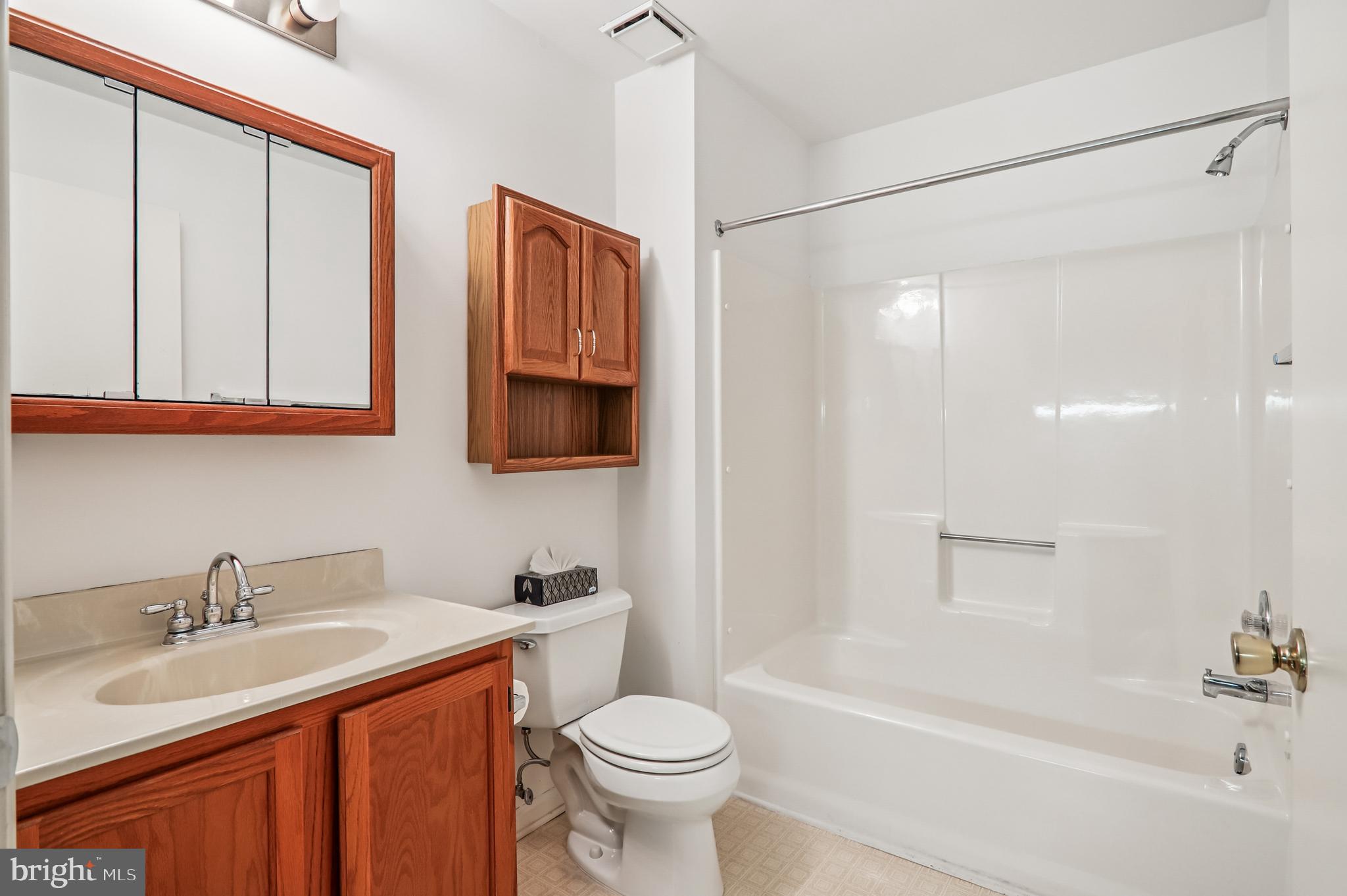 9272 Cherry Lane, Unit 75 Laurel, MD 20708 - Photo 25 of 37 a bathroom with a sink toilet and shower