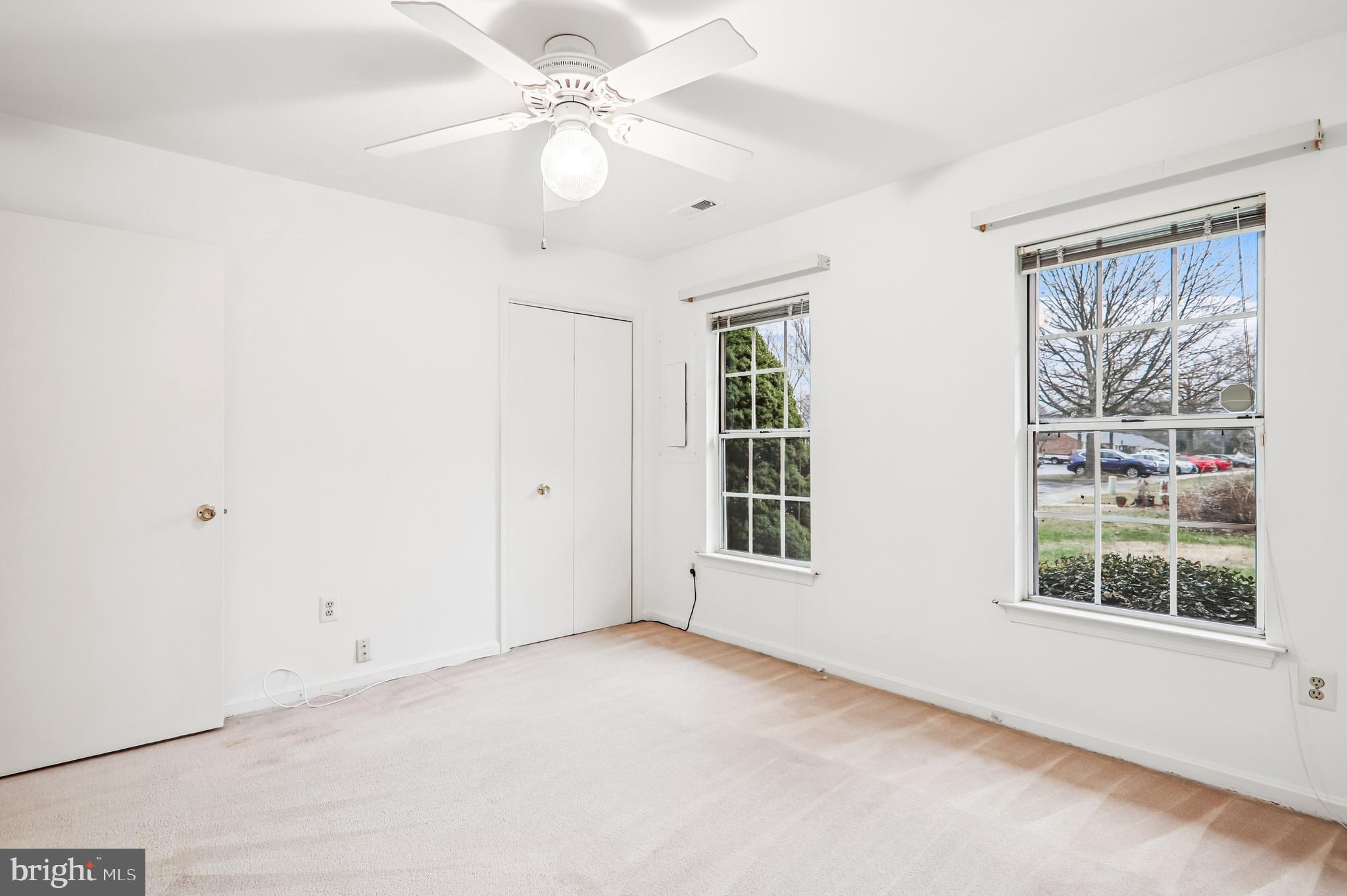 9272 Cherry Lane, Unit 75 Laurel, MD 20708 - Photo 28 of 37 an empty room with windows and ceiling fan