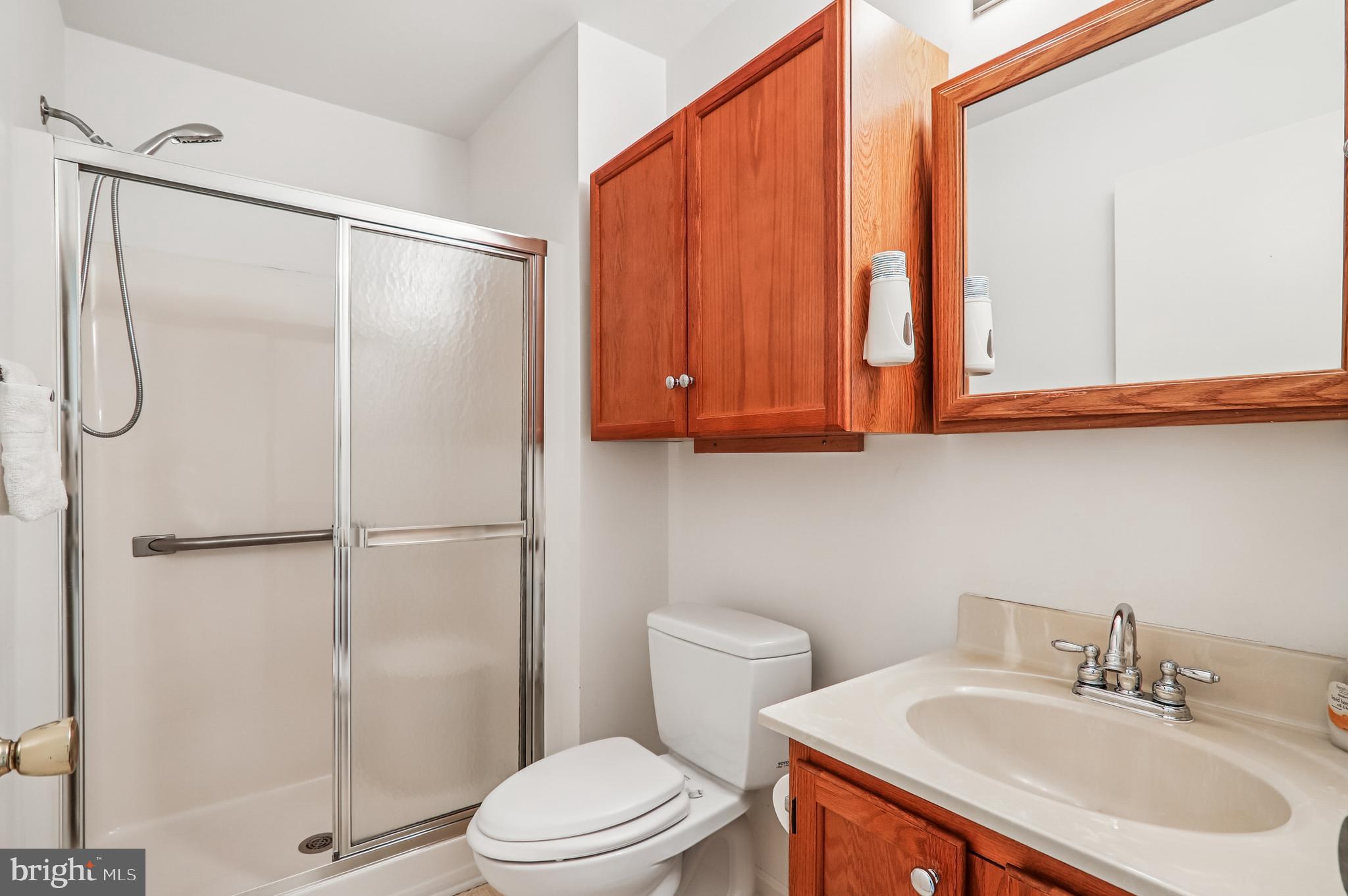 9272 Cherry Lane, Unit 75 Laurel, MD 20708 - Photo 30 of 37 a bathroom with a sink a toilet and shower