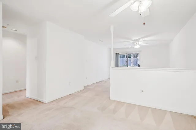 an empty room with kitchen view