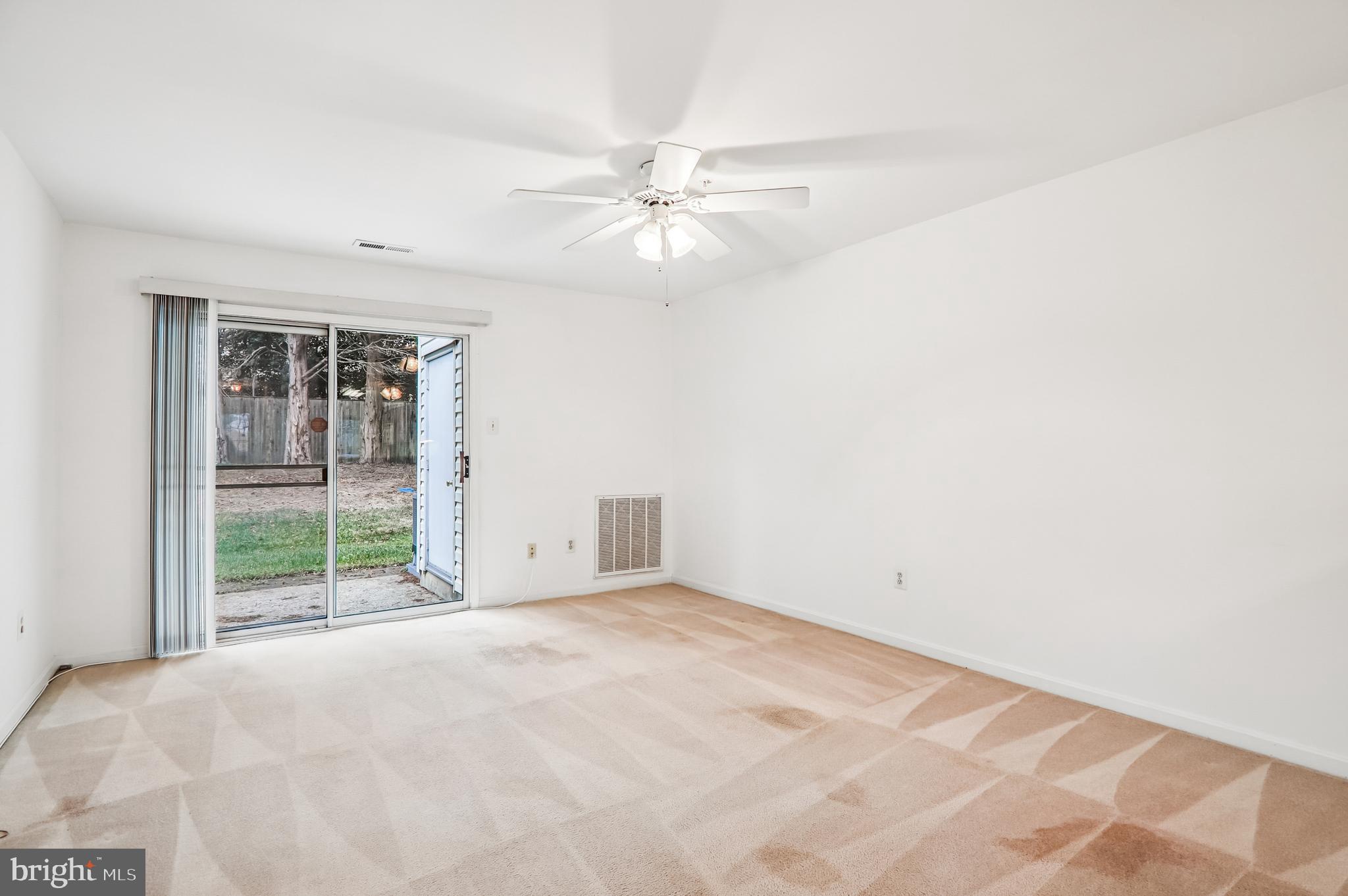 9272 Cherry Lane, Unit 75 Laurel, MD 20708 - Photo 10 of 37 an empty room with windows and fan