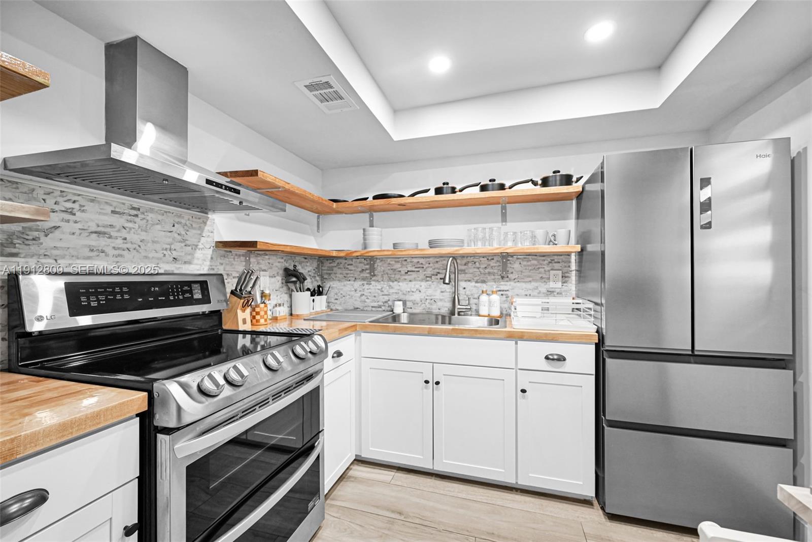 a kitchen with cabinets and steel stainless steel appliances