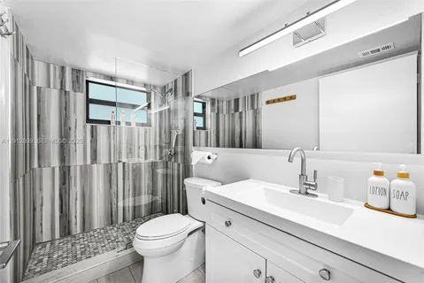 a bathroom with a sink toilet and shower