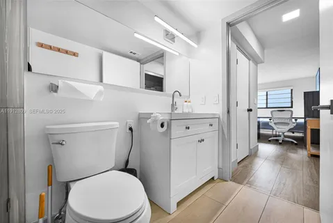 a white toilet sitting next to a bathroom sink
