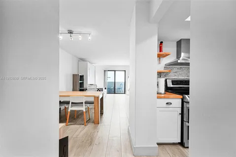 a view of a kitchen with dining room and wooden floor