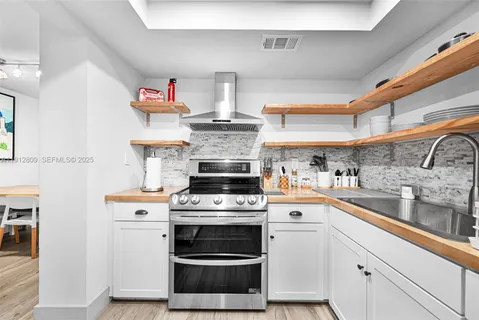 a kitchen with cabinets and steel stainless steel appliances