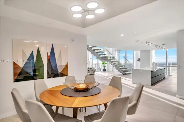 a dining room with furniture and wooden floor