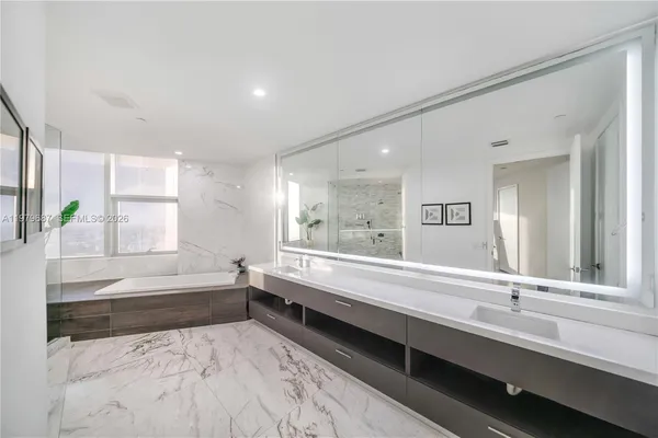 a bathroom with a bathtub and a sink