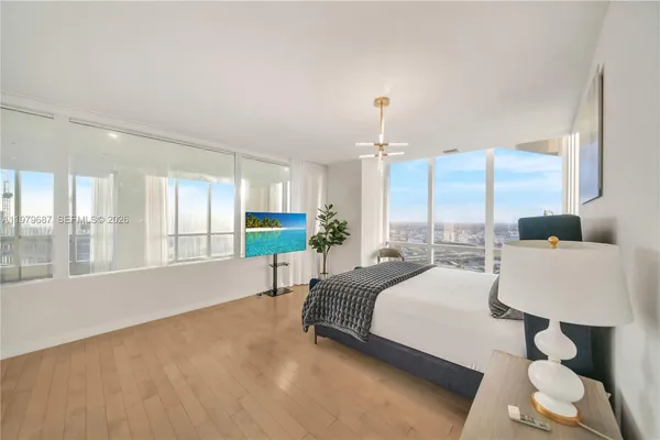 a spacious bedroom with a bed and a large window
