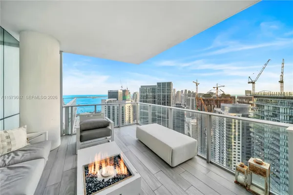 a balcony with furniture and city view