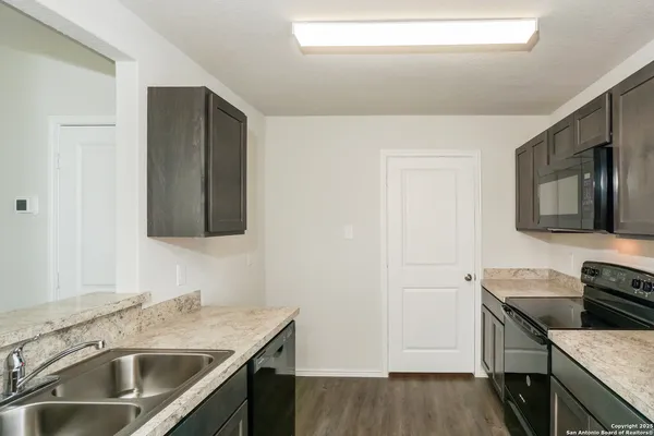 a kitchen with a sink stove and microwave