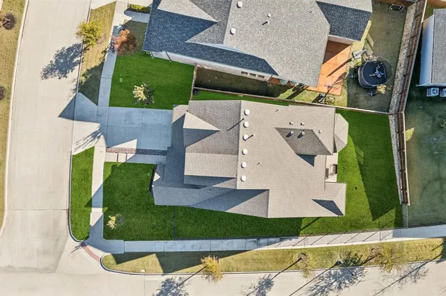 an aerial view of a house with a garden and trees