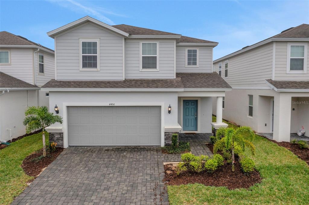 a front view of a house with a yard and garage