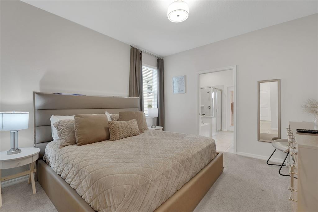 4450 Kaipo Road Davenport, FL 33897 - Photo 13 of 66 a bedroom with a bed and with furniture