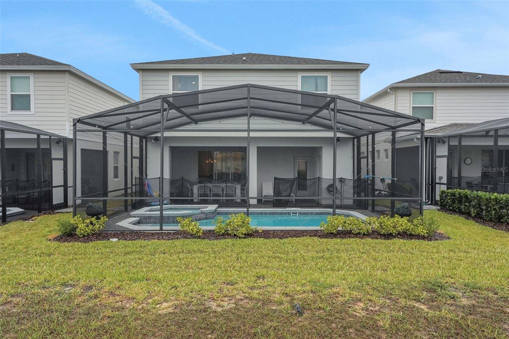 4450 Kaipo Road Davenport, FL 33897 - Photo 17 of 66 a view of a house with a yard patio and swimming pool