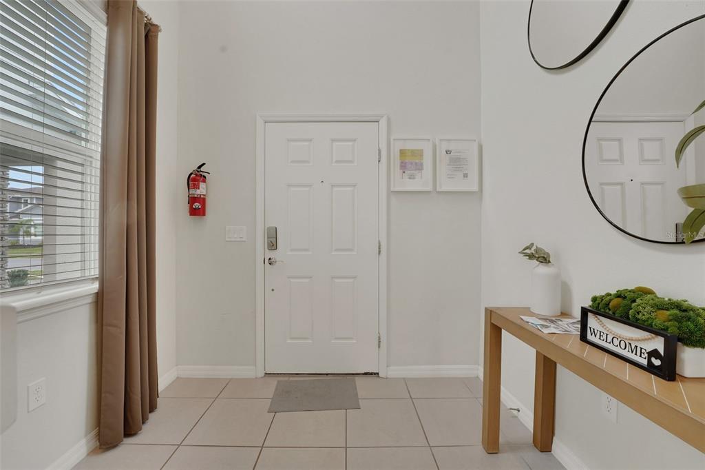 4450 Kaipo Road Davenport, FL 33897 - Photo 2 of 66 a bathroom with a granite countertop shower a mirror and a sink
