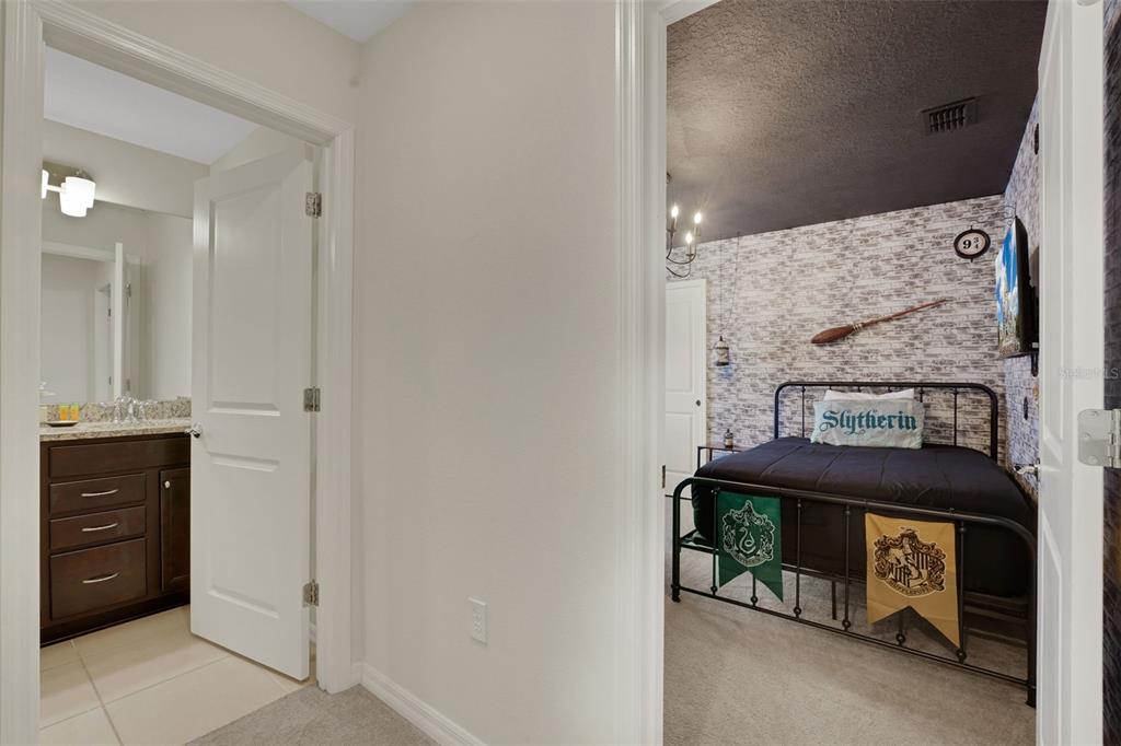 4450 Kaipo Road Davenport, FL 33897 - Photo 26 of 66 a bathroom with a sink and a mirror
