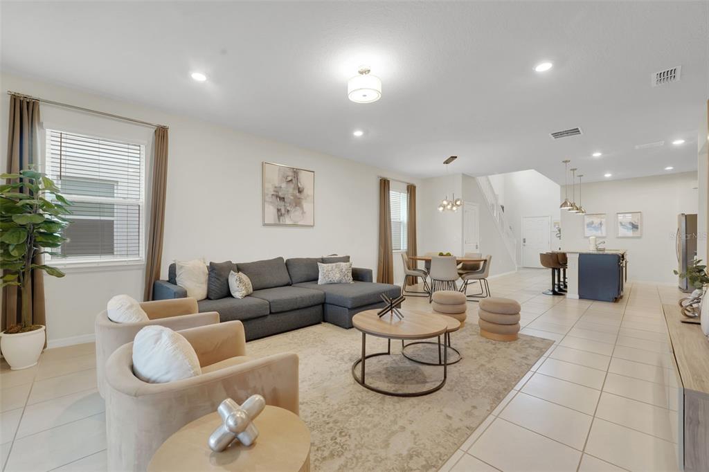 4450 Kaipo Road Davenport, FL 33897 - Photo 3 of 66 a living room with fireplace furniture and a potted plant