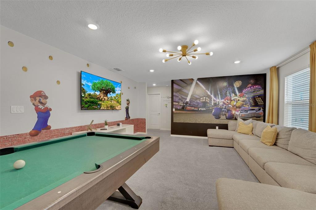 4450 Kaipo Road Davenport, FL 33897 - Photo 34 of 66 a living room with furniture pool and a flat screen tv