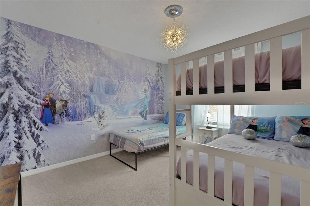 4450 Kaipo Road Davenport, FL 33897 - Photo 39 of 66 a bedroom with furniture and a chandelier