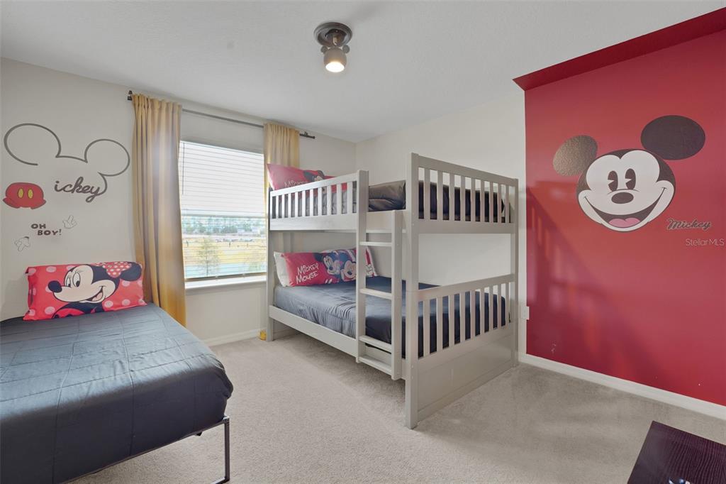 4450 Kaipo Road Davenport, FL 33897 - Photo 40 of 66 a bedroom with a bed and a window