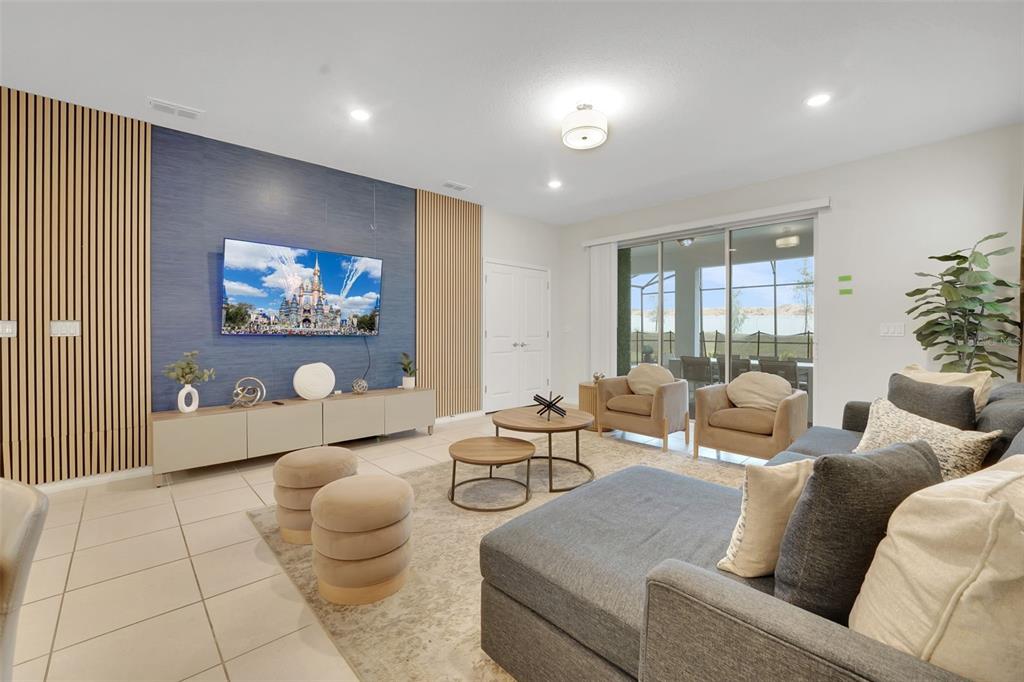 4450 Kaipo Road Davenport, FL 33897 - Photo 4 of 66 a living room with furniture and a painting on the wall