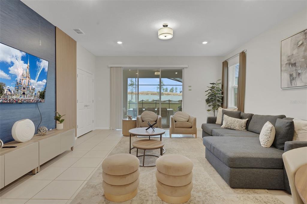 4450 Kaipo Road Davenport, FL 33897 - Photo 6 of 66 a living room with furniture and a large window