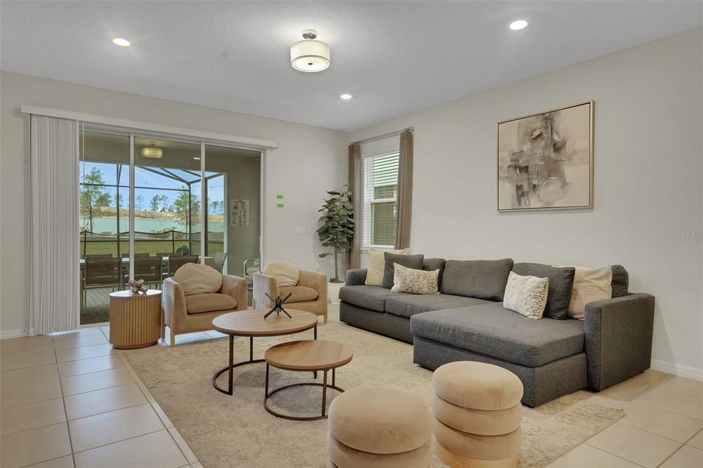 4450 Kaipo Road Davenport, FL 33897 - Photo 7 of 66 a living room with furniture and a large window