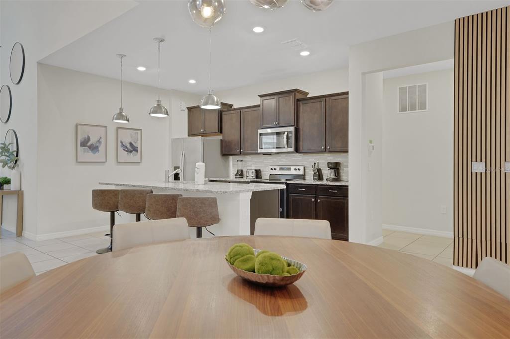 4450 Kaipo Road Davenport, FL 33897 - Photo 8 of 66 a living room with stainless steel appliances furniture a rug and a window