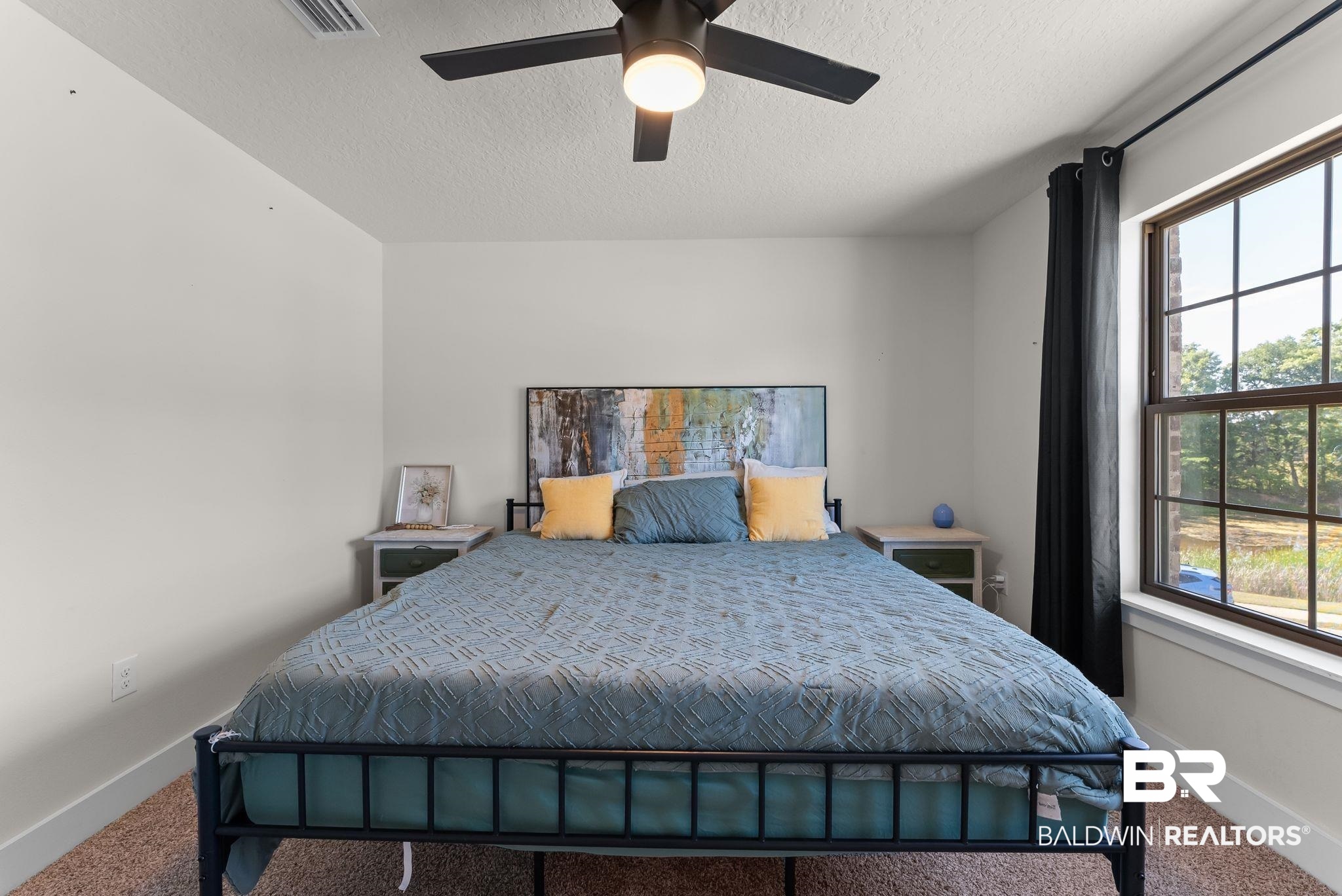 16607 Prado Loop Loxley, AL 36551 - Photo 21 of 46 Carpeted room featuring a ceiling fan, white walls, and a large window with muntins