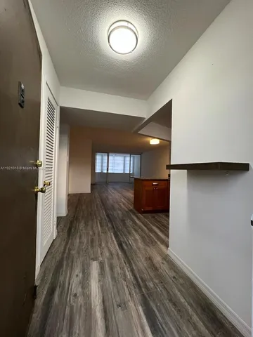 a view of a room with wooden floor