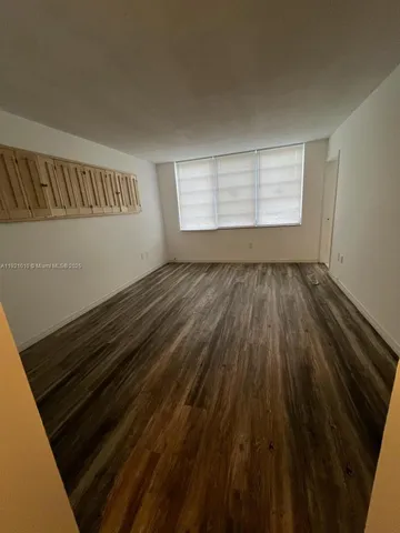 a view of an empty room and wooden floor