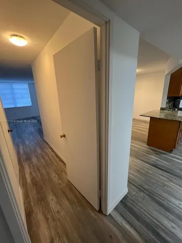 a view of a kitchen from a hallway