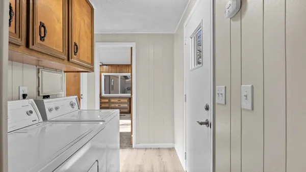 a view of washer and dryer with wooden floor