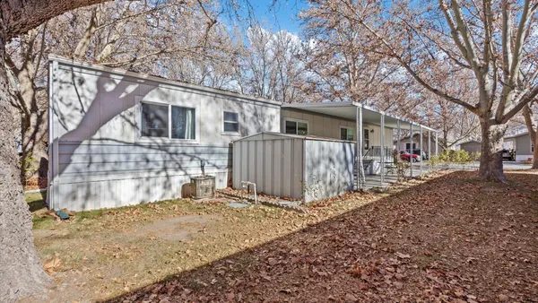 a view of a house with a yard covered in snow