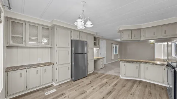 a kitchen with stainless steel appliances granite countertop a refrigerator a stove sink and cabinets