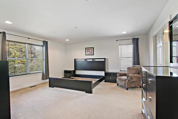 a living room with furniture and large windows