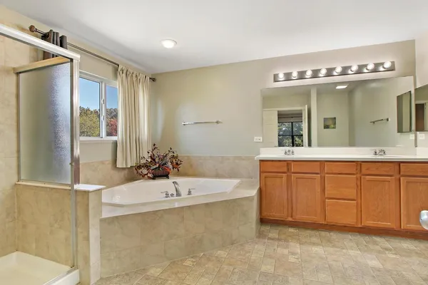 a bathroom with a sink mirror and a bathtub