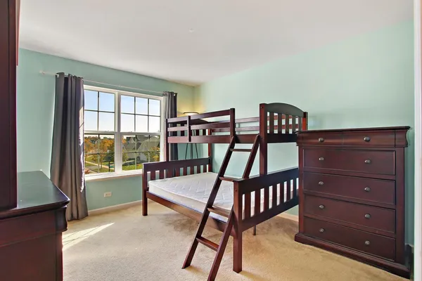 a bedroom with furniture and a window