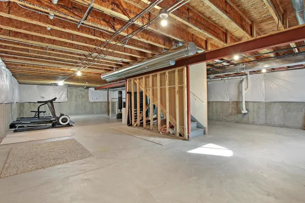 a room with gym equipment and a rug