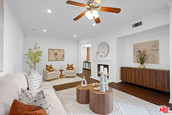 a living room with furniture a window and a chandelier