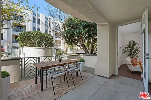 a table and chairs in front of a building