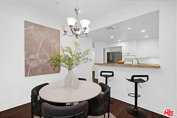 a view of a dining room with furniture wooden floor and chandelier