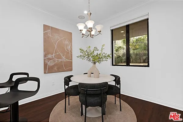a view of a dining room with furniture and chandelier