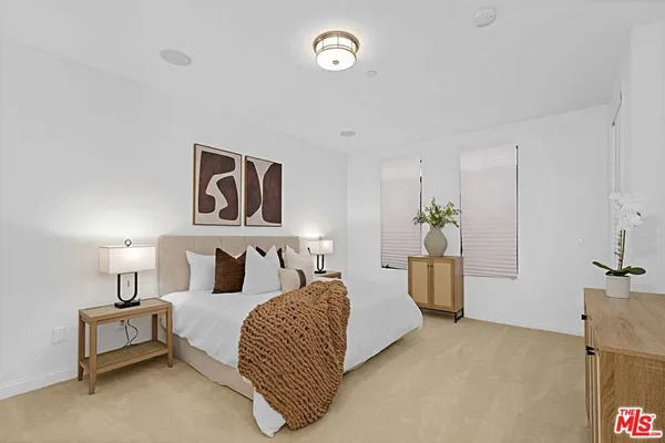 a bedroom with furniture and a potted plant