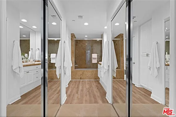 a bathroom with a glass shower door and a glass door shower