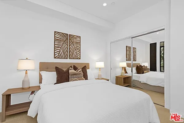 a bedroom with a bed and a lamp