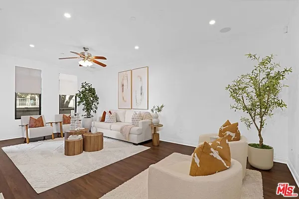 a living room with furniture and flowers