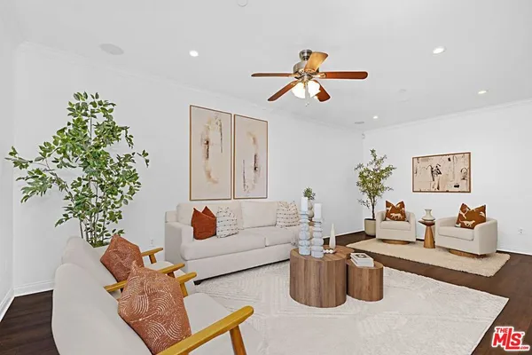 a living room with furniture potted plant and a chandelier