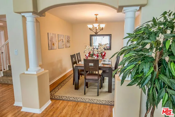 a large kitchen with stainless steel appliances granite countertop a lot of counter space and wooden floors